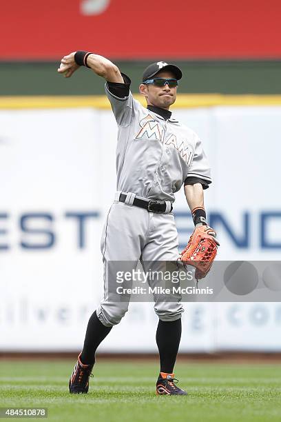 Ichiro Suzuki of the Miami Marlins throws in the outfield between inning during the game against the Milwaukee Brewers at Miller Park on August 19,...