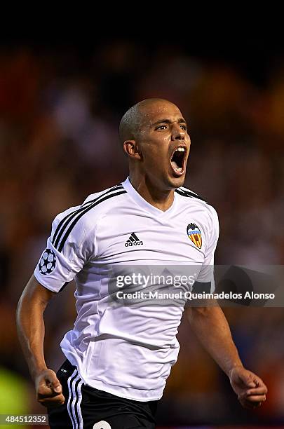 Sofiane Feghouli of Valencia celebrates scoring his team's third goal during the UEFA Champions League Qualifying Round Play Off First Leg match...