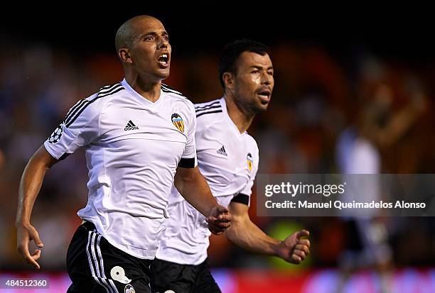 Sofiane Feghouli of Valencia celebrates scoring his team's third goal with his teammate Javi Fuego during the UEFA Champions League Qualifying Round...