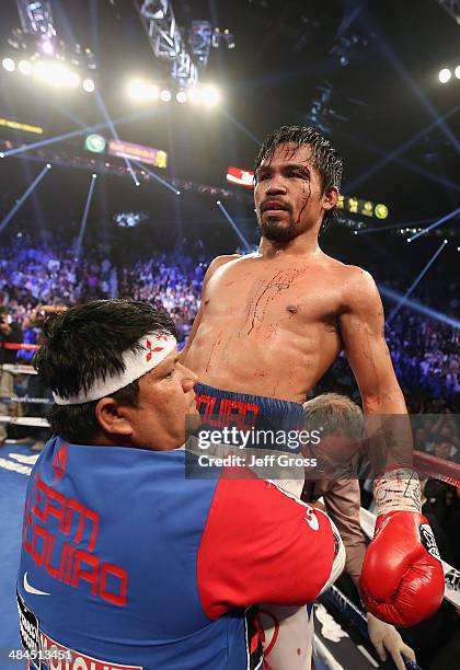 Manny Pacquiao is hoisted up by his corner following his match against Timothy Bradley at the MGM Grand Garden Arena on April 12, 2014 in Las Vegas,...