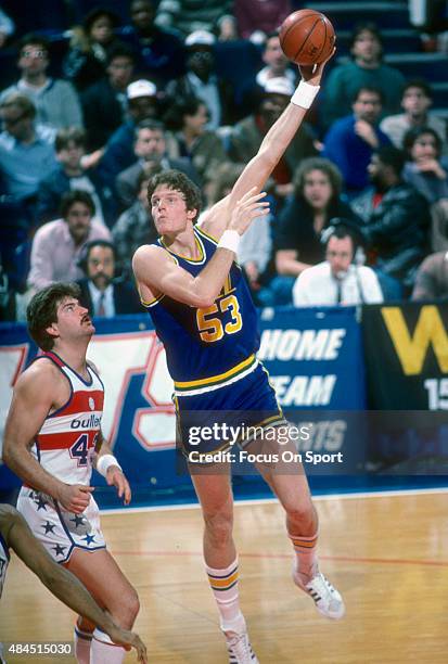 Mark Eaton of the Utah Jazz shoots over Jeff Ruland of the Washington Bullets during an NBA basketball game circa 1984 at the Capital Centre in...
