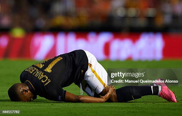 Ivan Cavaleiro of Monaco lies injured on the pitch during the UEFA Champions League Qualifying Round Play Off First Leg match between Valencia CF and...