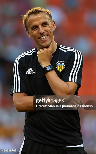 Valencia CF assistant coach Phil Neville smiles prior to the UEFA Champions League Qualifying Round Play Off First Leg match between Valencia CF and...