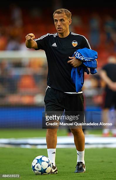Valencia CF assistant coach Phil Neville gestures prior to the UEFA Champions League Qualifying Round Play Off First Leg match between Valencia CF...