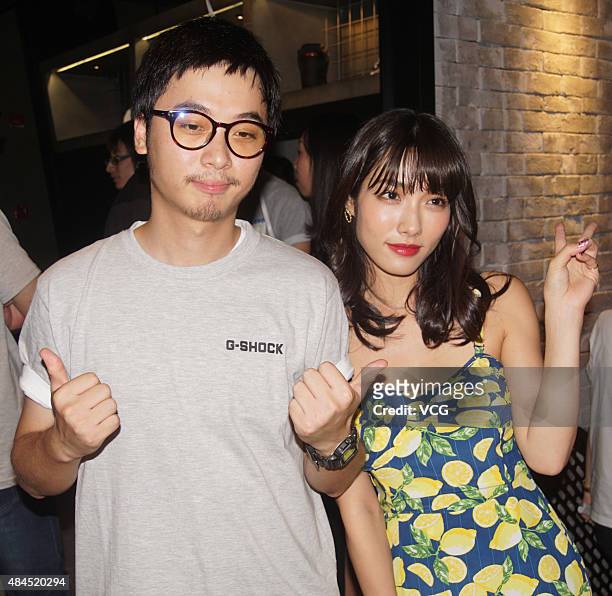 Anna Konno, Japanese gravure idol from Kanagawa Prefecture, poses with a man while attending a commercial activity on August 19, 2015 in Shanghai,...