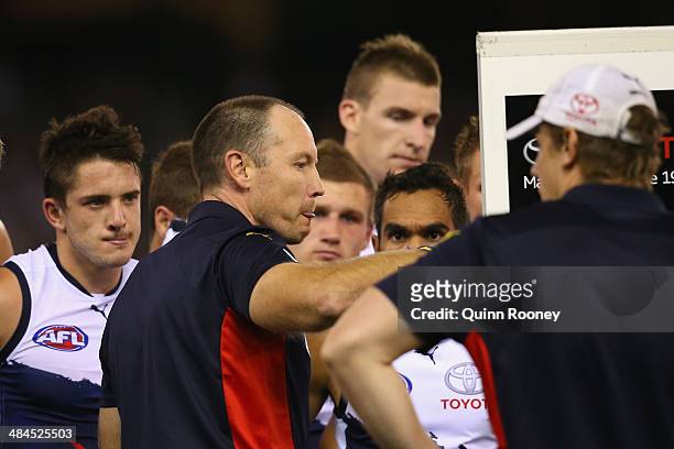 Brenton Sanderson the coach of the Crows talks to his players during the round four AFL match between the St Kilda Saints and the Adelaide Crows at...