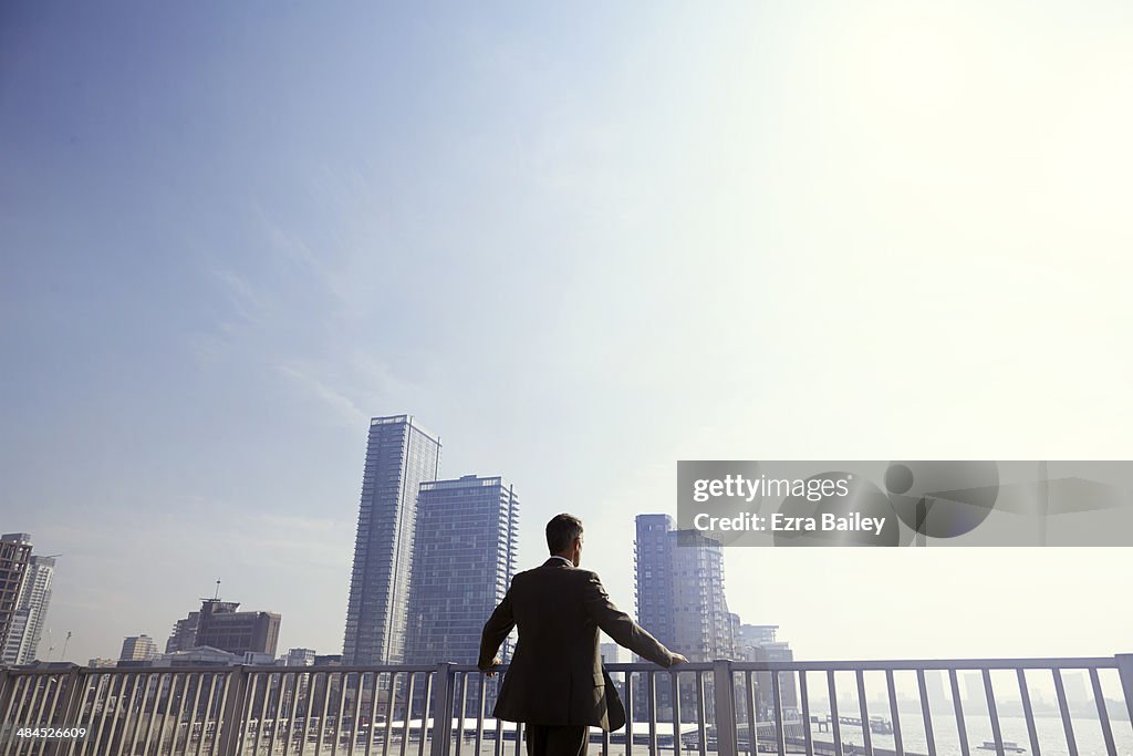 Businessman looking out over the city.