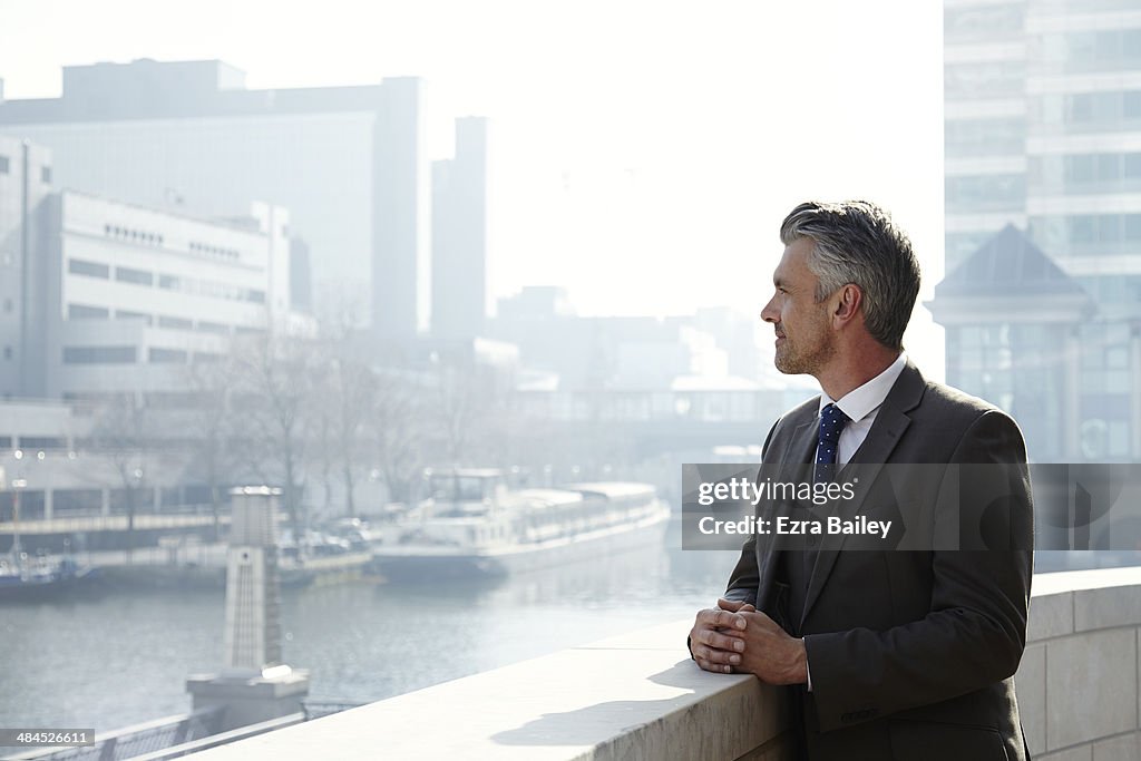 Business man looking out over the city.