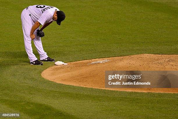Relief pitcher Rafael Betancourt of the Colorado Rockies reacts after giving up a two run triple to Jayson Werth of the Washington Nationals to break...