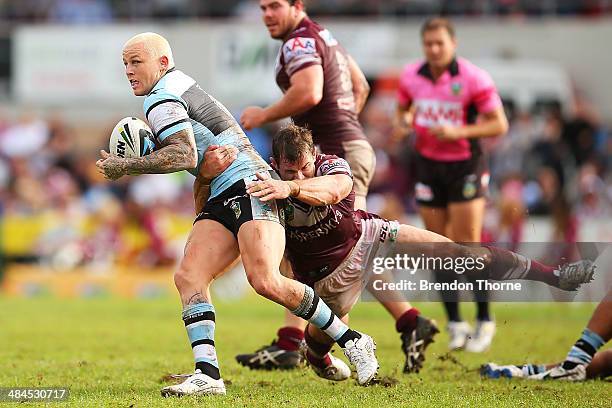 Todd Carney of the Sharks is tackled by Brenton Lawrence of the Sea Eagles during the round 6 NRL match between the Manly-Warringah Sea Eagles and...