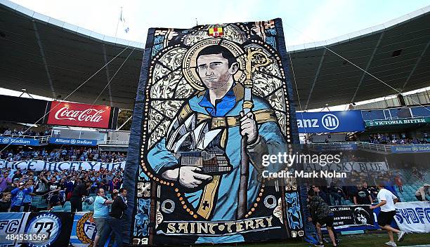 Banner depicting Terry McFlynn of Sydney is held up before the round 27 A-League match between Sydney FC and Perth Glory at Allianz Stadium on April...