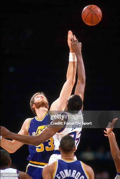 Mark Eaton of the Utah Jazz battles for the tip-off with Charles Jones of the Washington Bullets during an NBA basketball game circa 1989 at the...