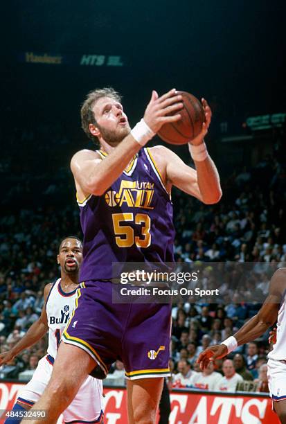 Mark Eaton of the Utah Jazz grabs a rebound against the Washington Bullets during an NBA basketball game circa 1990 at the Capital Centre in...