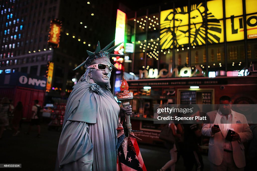 Spotlight On Times Square As Painted-Topless Women Draw Ire Of Mayor And Governor