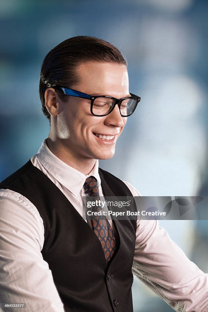 Laughing man wearing dark rimmed glasses