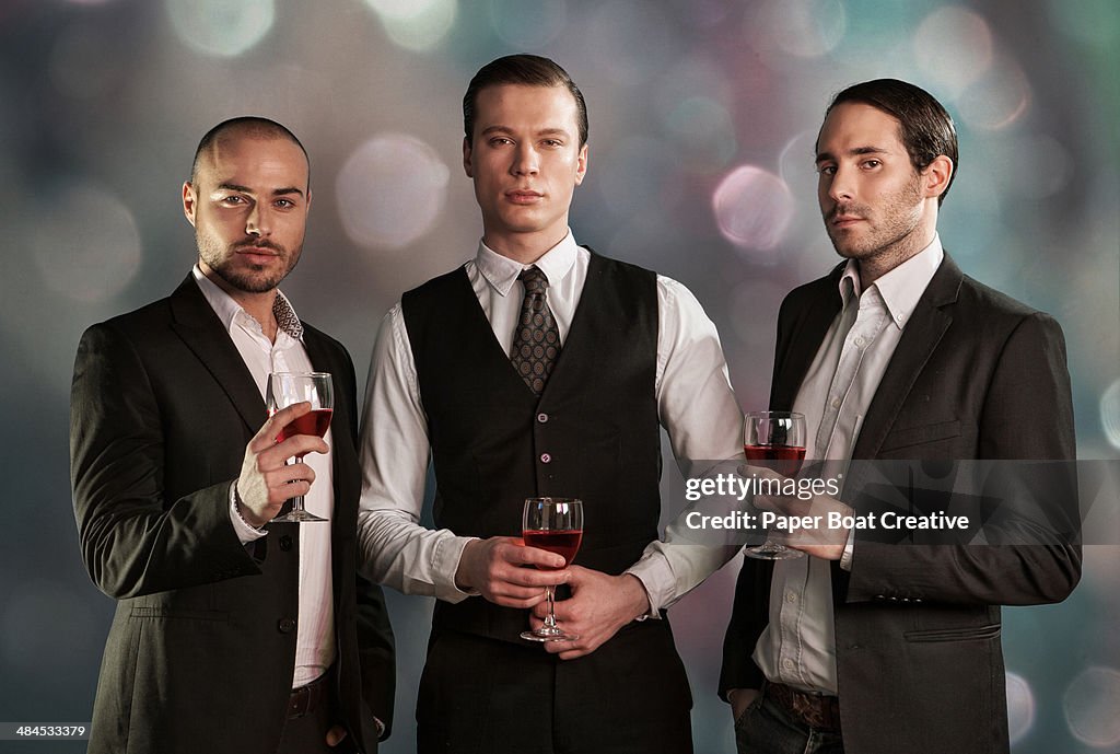 Formal portrait of three men in business suits