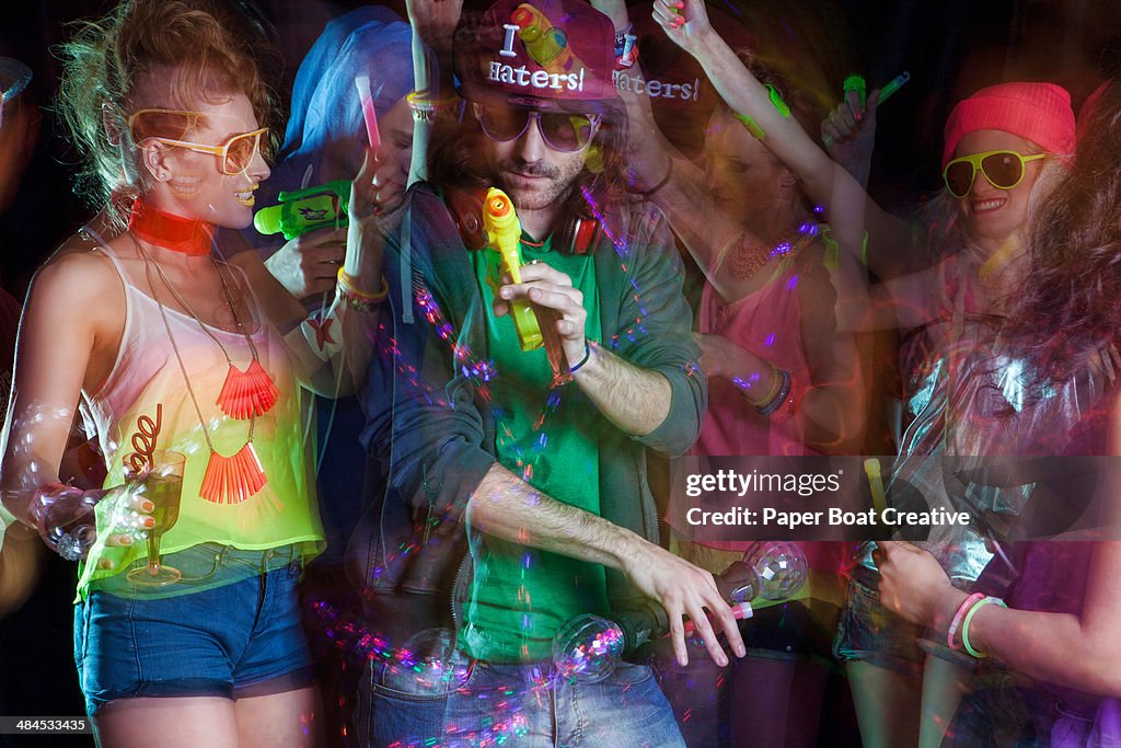 Group of young people dancing in a techno club