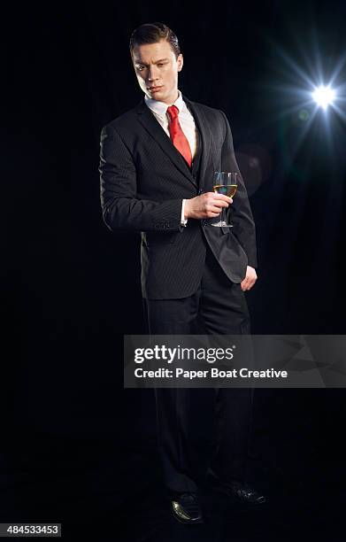 man standing and looking serious at a party - vip nightclub stock pictures, royalty-free photos & images