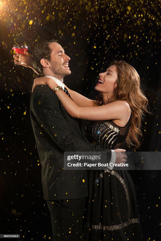 Couple laughing and dancing in a formal party