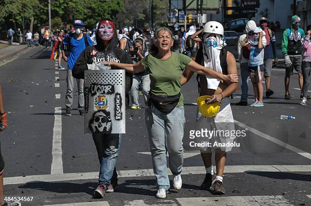 Riot police forces intervene activists with tear gas during the ongoing anti-government protest in the capital Caracas, Venezuela on April 13, 2014.