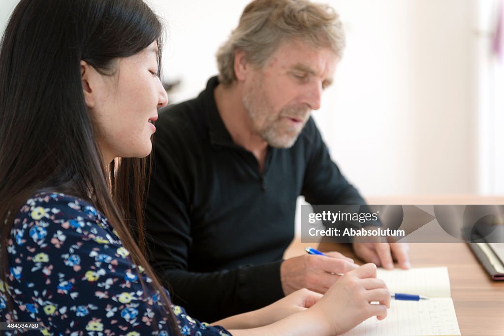 Chinese Woman and Srenior Caucasian Studying Chinese Numbers, Slovenia, Europe