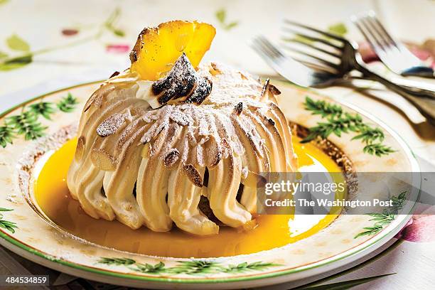 Baked Alaska at Le Viex Logis restaurant in Bethesda, MD. 2014. Baked Alaska dessert topped with pinapple and sauce.