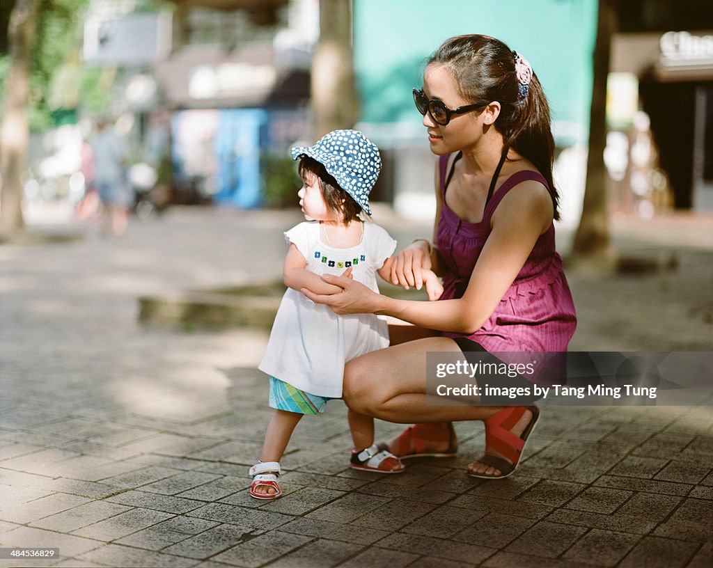 Young mom a baby girl playing