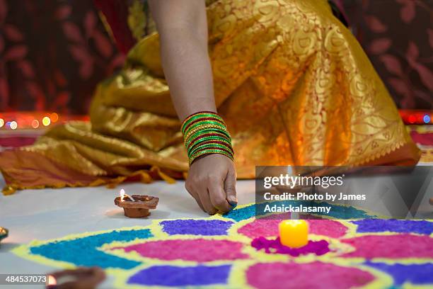 diwali rangoli decorated with diyas & candle - rangoli stock-fotos und bilder