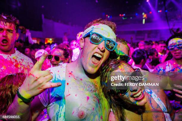 Dancefans are covered with neon paint during the Neonsplash Paint Party in the Heineken Music Hall in Amsterdam, on April 13, 2014. The sold-out...