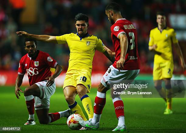 Alex Mowatt of Leeds United is tackled by Derrick Williams of Bristol City during the Sky Bet Championship match between Bristol City and Leeds...