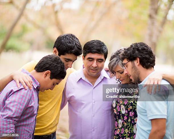 family contemplating - couple praying stock pictures, royalty-free photos & images