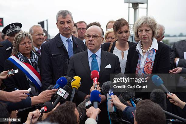 Britain's Home Secretary, Theresa May and Natacha Bouchart, the mayor of Calais , look on as French Interior Minister Bernard Cazeneuve addresses the...