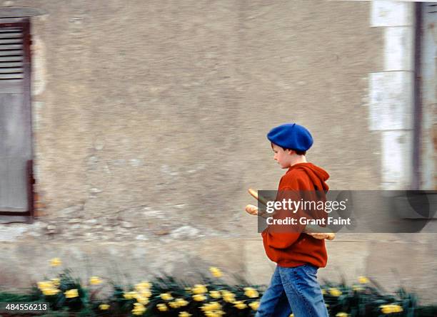 boy carrying baguettes - french baguette stock-fotos und bilder