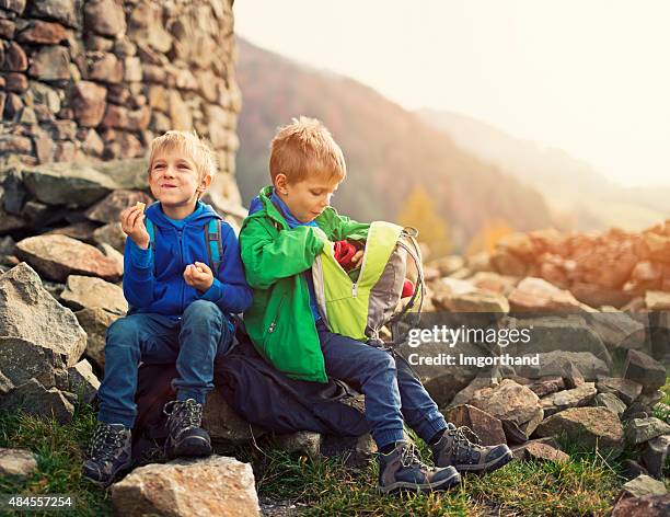 little hikers resting and eating a snack - kids hiking stock pictures, royalty-free photos & images