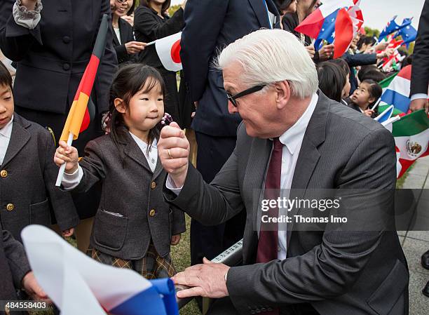 German Foreign Minister Frank-Walter Steinmeier speaks to a girl during his visit to the monument for the 1945 atomic bomb victims at the Hiroshima...