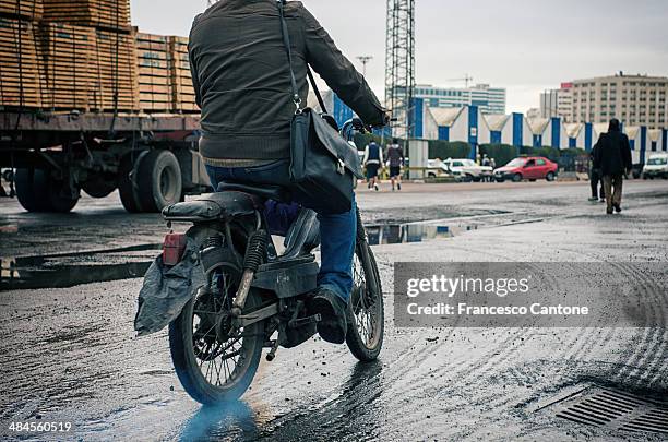 biker on muddy street in casablanca, morocco - trail moto maroc stock pictures, royalty-free photos & images