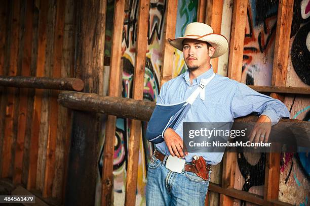 injured cowboy portrait in barn arm in sling - clavicle stock pictures, royalty-free photos & images