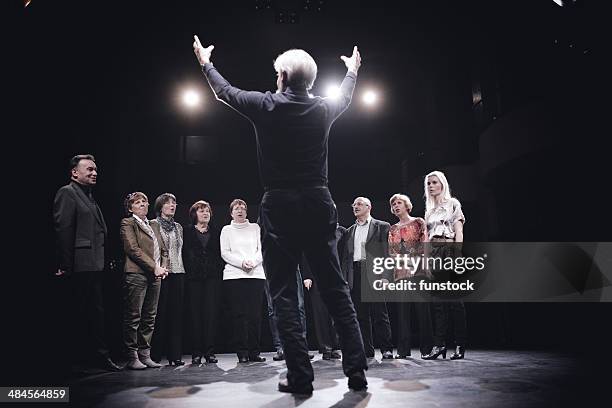 conductor and choir on stage - koor stockfoto's en -beelden