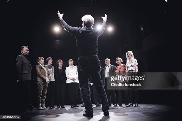 conductor and choir on stage - choir singing stock pictures, royalty-free photos & images