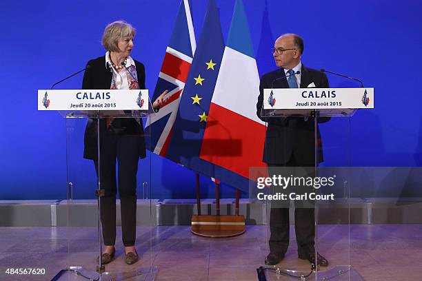Britain's Home Secretary Theresa May and French Interior Minister Bernard Cazeneuve speak to the media at a press conference after signing an...