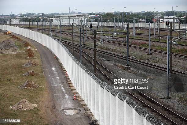White security fence, funded by Britain in an effort to counter attempts by migrants to board cross-channel trains, is pictured following a visit by...