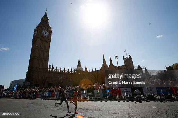 Mo Farah of Great Britain and Emmanuel Mutai of Kenya run past the Houses of Parliament during the Virgin Money London Marathon on April 13, 2014 in...