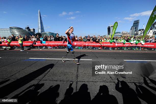 Richard Whitehead of Great Britain is applauded as he cross Tower Bridge during the Virgin Money London Marathon on April 13, 2014 in London, England.