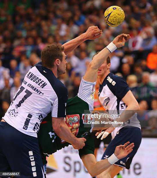 Michael Knudsen of Flensburg challenges for the ball with Bartlomiej Jaszka of Berlin during the DHB Pokal handball final match between Flensburg...