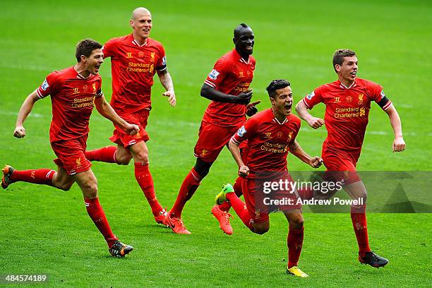 Philippe Coutinho of Liverpool celebrates his goal with Steven Gerrard and team mates to make it 3-2 during the Barclays Premier Leuage match between...