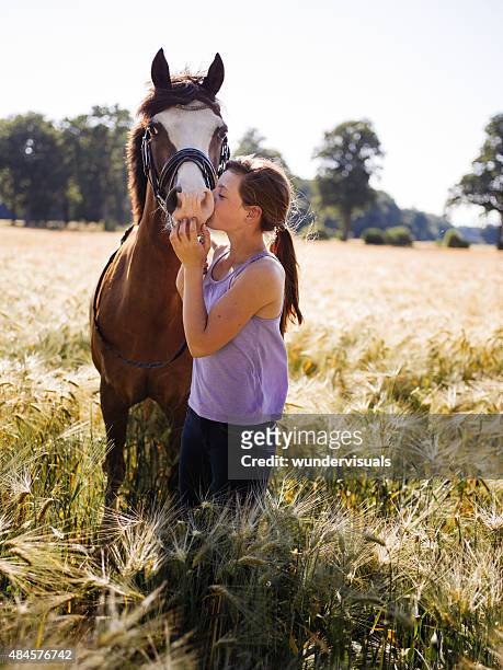 lovingly girl giving her horse a kiss on it's nose - girl hold nose stock pictures, royalty-free photos & images