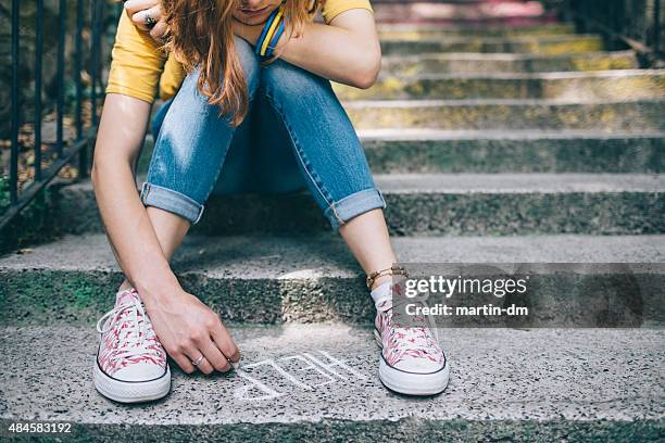 unahppy girl writes help on the ground - depression anxiety stock pictures, royalty-free photos & images