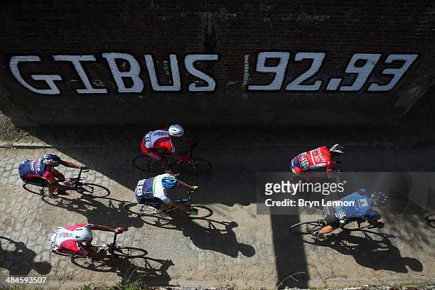 The peloton ride through Pont Gibus during the 112th edition of the Paris - Roubaix cycle race from Compiegne to Roubaix on April 13, 2014 in...