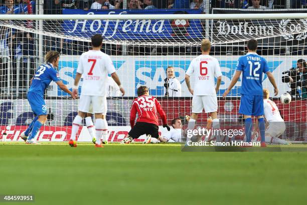 Jannik Vestergaard of Hoffenheim scores his team's second goal against goalkeeper Marwin Hitz of Augsburg during the Bundesliga match between 1899...