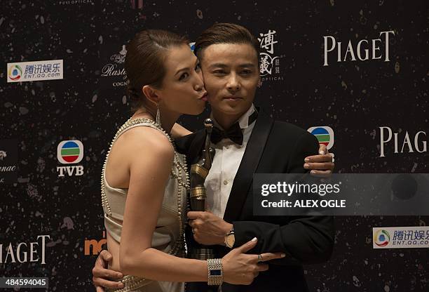 Zhang Jin with his wife Ada Choi poses with his trophy after winning in the Best Supporting Actor category for his role in the film "The Grandmaster"...